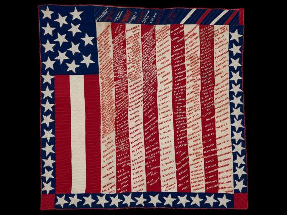 picture of a quilted American flag with writing on it